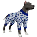 Dog wearing a shark-patterned pajama set on a white background