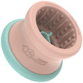 Pink and teal puzzle toy with textured interior on a white background