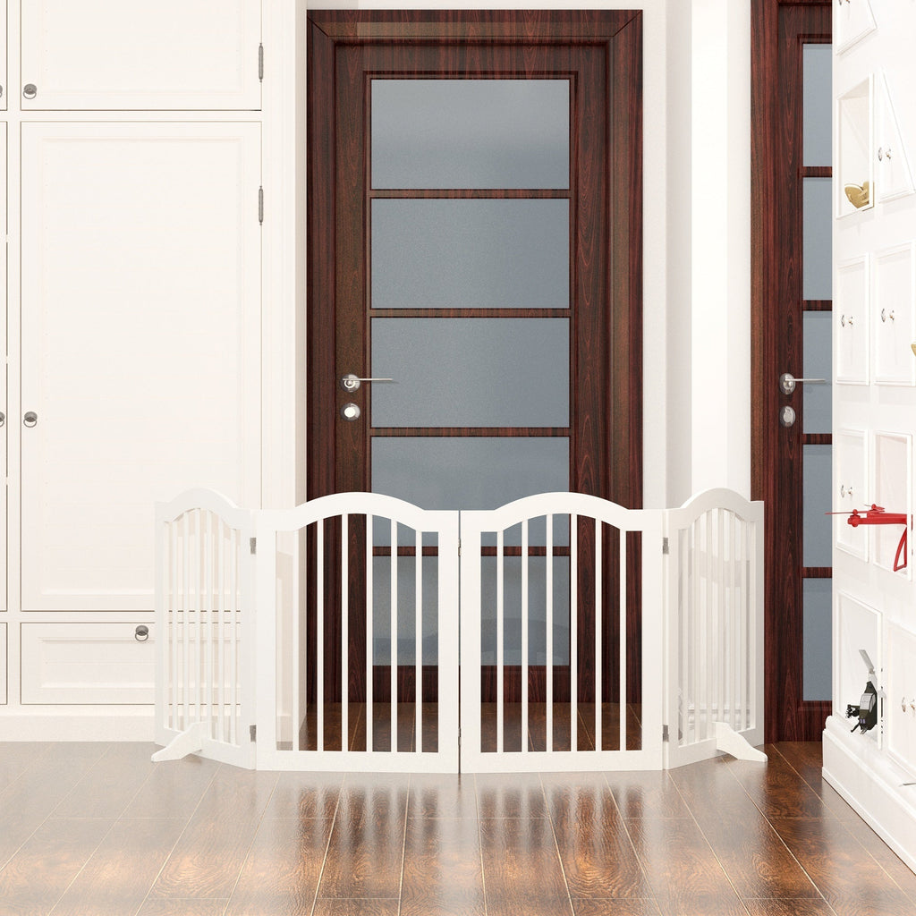 White baby gate in a hallway with wooden doors.