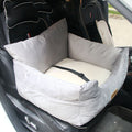 Pet car seat in a vehicle with a gray cushion and white liner.