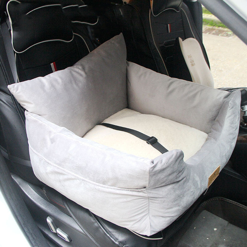Pet car seat in a vehicle with a gray cushion and white liner.