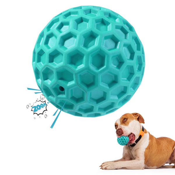Dog playing with a blue textured ball on a white background
