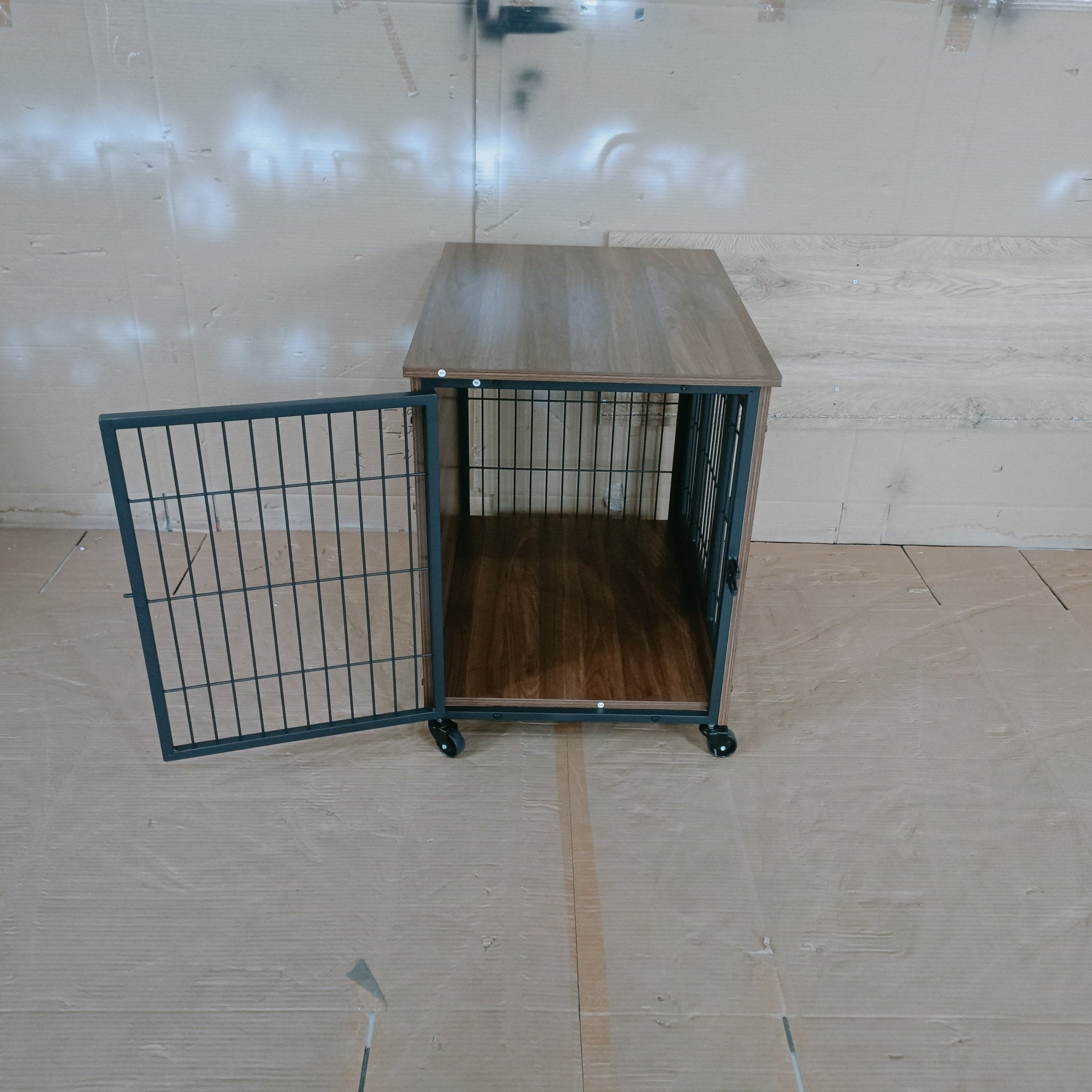 Metal pet crate with wooden interior on a tiled floor