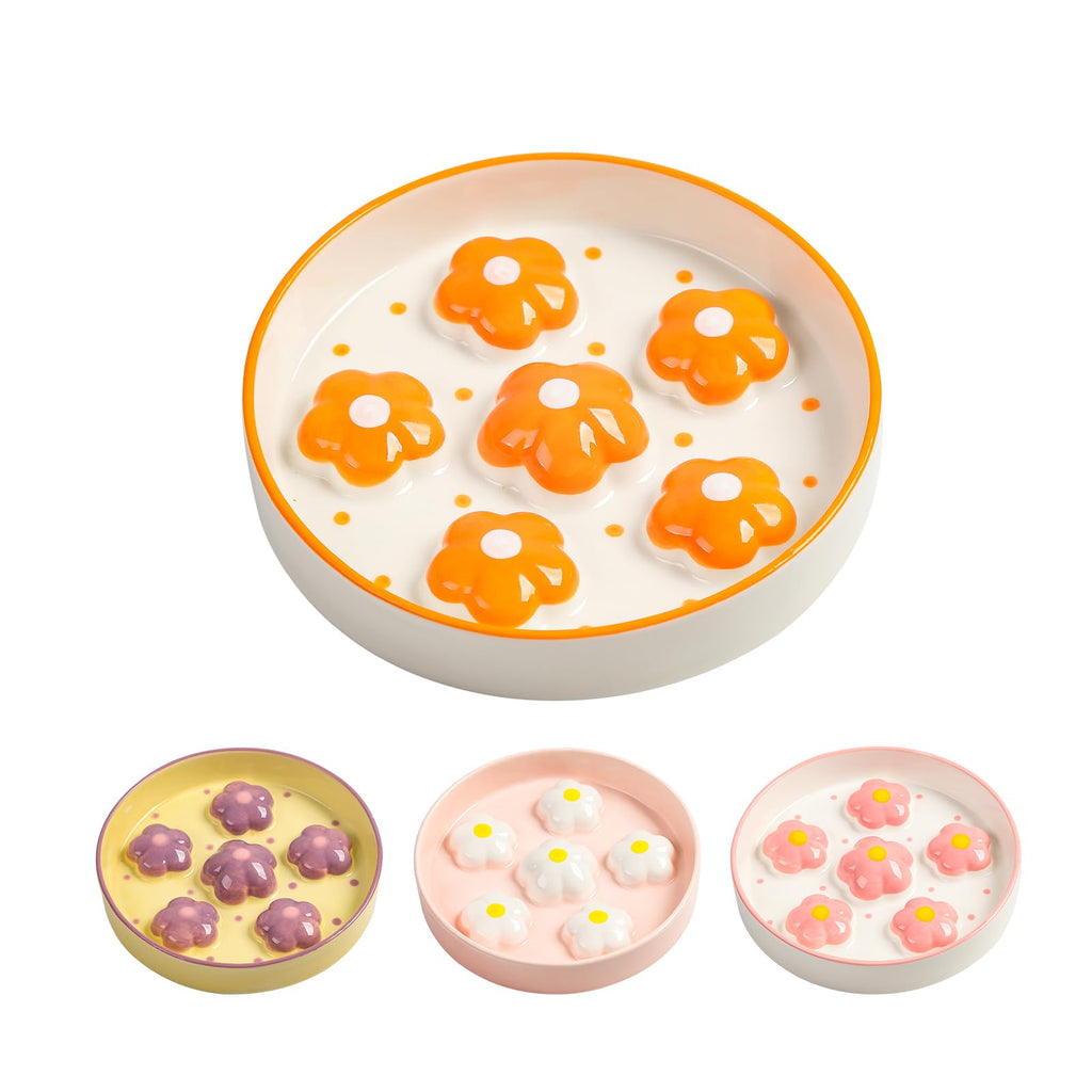 Set of small round dishes with floral designs on a white background